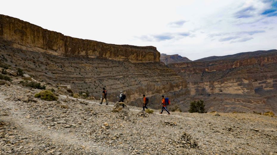 Trekking along the balcony walk at Jebel Shams, often called the Grand Canyon of the Middle East.