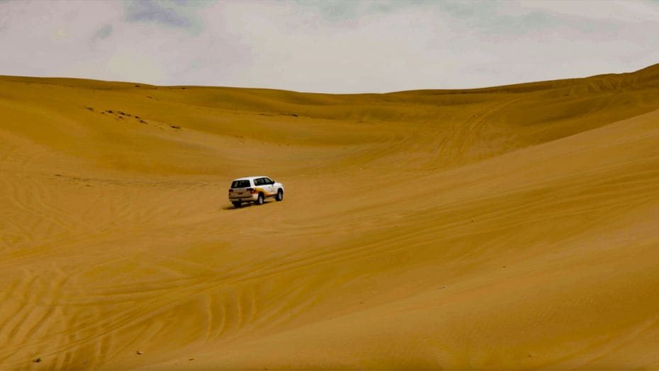 A 4WD taking passengers across the Sharqiyah Sands desert in Oman