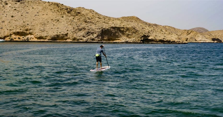  A tourist goes paddle boarding in the waters of Bandar Khayran near Muscat.