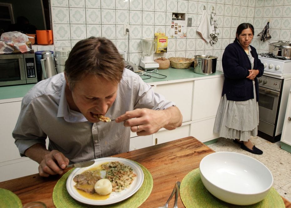 BoliviaDanish chef Claus Meyer (left) eats a typical Bolivian dish called ‘falso conejo’