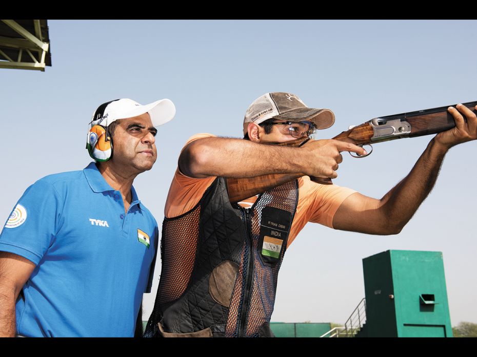 The Indian team’s shotgun coach, former Olympian Mansher Singh (behind), is at the Dr Karni Si