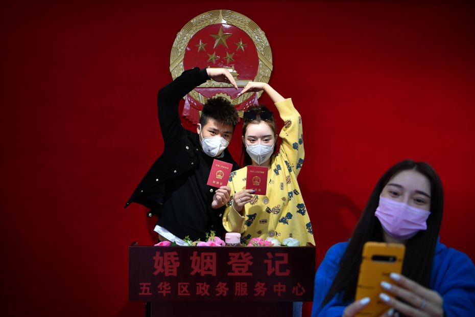 CHINA: A couple wearing face masks pose for photos after registering their marriage amid coronavirus