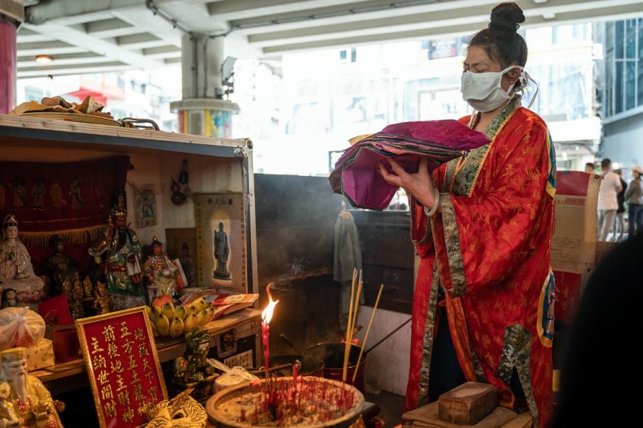 HONG KONG: A mask-wearing woman performs a 'villain hitting' ceremony on the day of Jingzhe in Cause