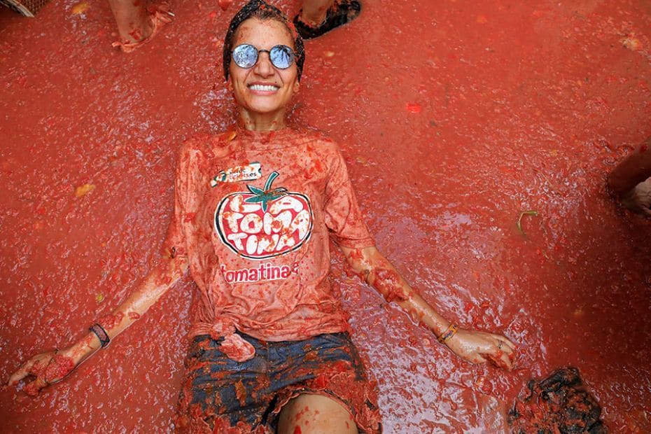 A participant revels in tomato pulp as people attend the annual tomato fight festival 'La Tomatina' 