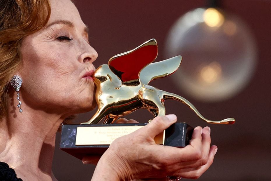 Sigourney Weaver poses with the Golden Lion award for lifetime achievement on the red carpet during 