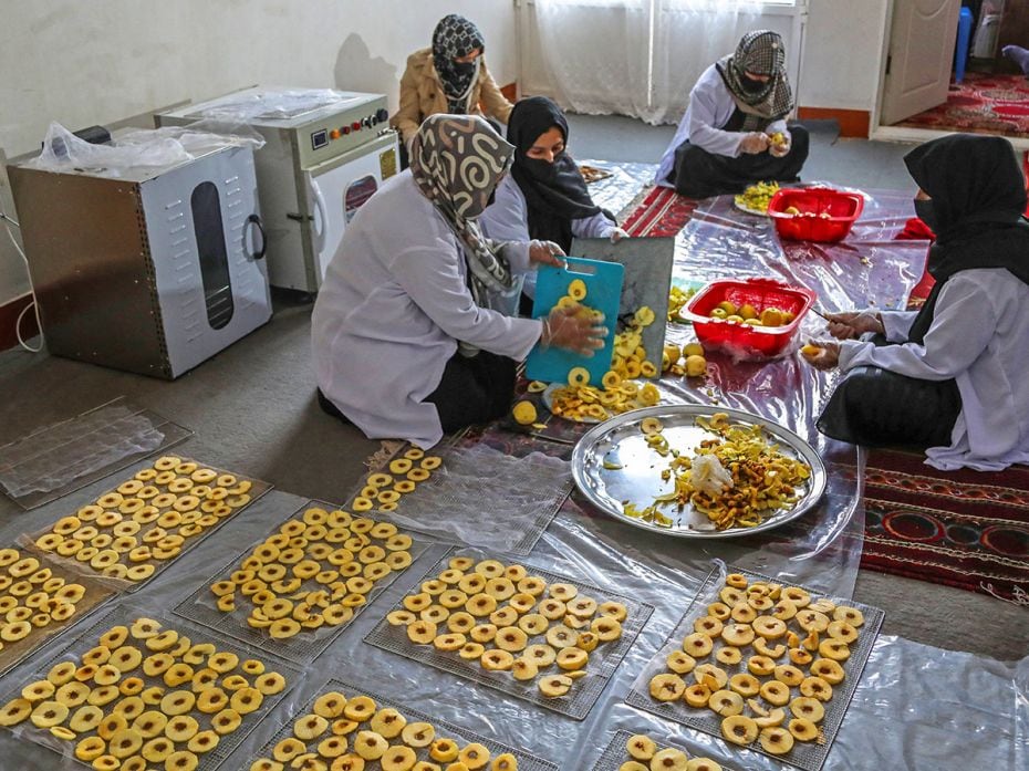 Afghan women prepare air fryer apple chips at a factory on November 17, 2024, in Herat, Afghanistan,