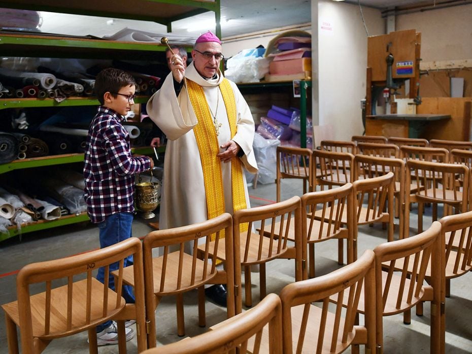 A bishop sprinkles holy water in the air on November 18, 2024, to bless the new chairs for Notre-Dam
