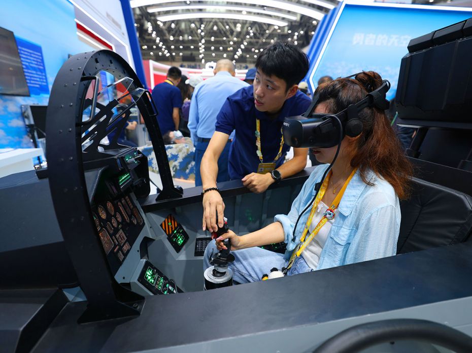 A visitor experiences flight potential detection systems in a Chinese People's Liberation Army booth