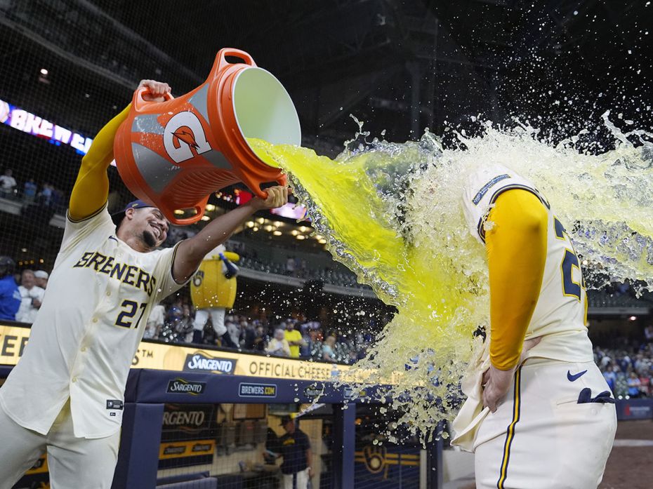 Willy Adames of the Milwaukee Brewers dunks William Contreras with a sports drink following a 5-3 wi