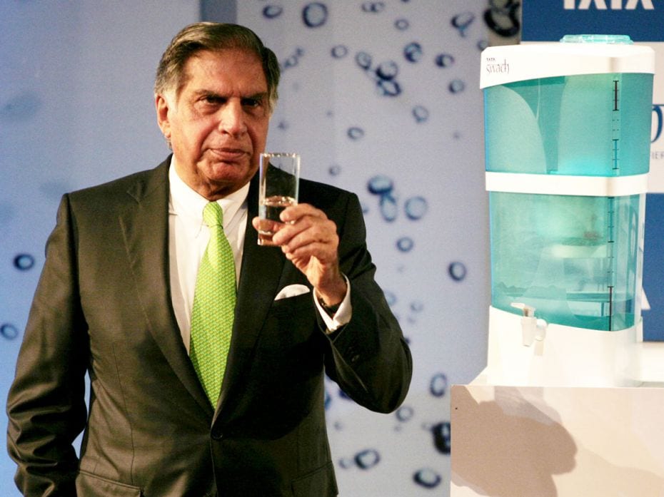 Ratan Tata, Chairman of Tata Group holds a glass of water from a Swach water filter during the produ