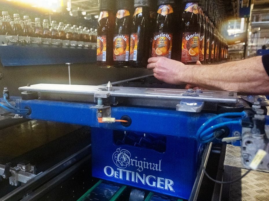 A file photo shows a cola mix drink filled into crates at the Oettinger brewery in Bavaria, Oettinge