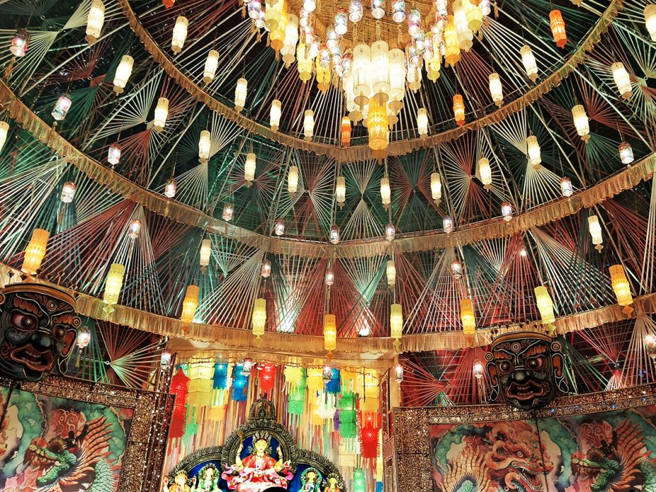 A stunning modern rendition of a pandal space in Tibetan Buddhist art style presents Durga, like the