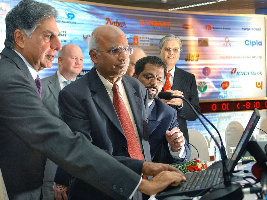 Tata Group Chairman Ratan Tata presses a key on a laptop to list India's largest software company, T