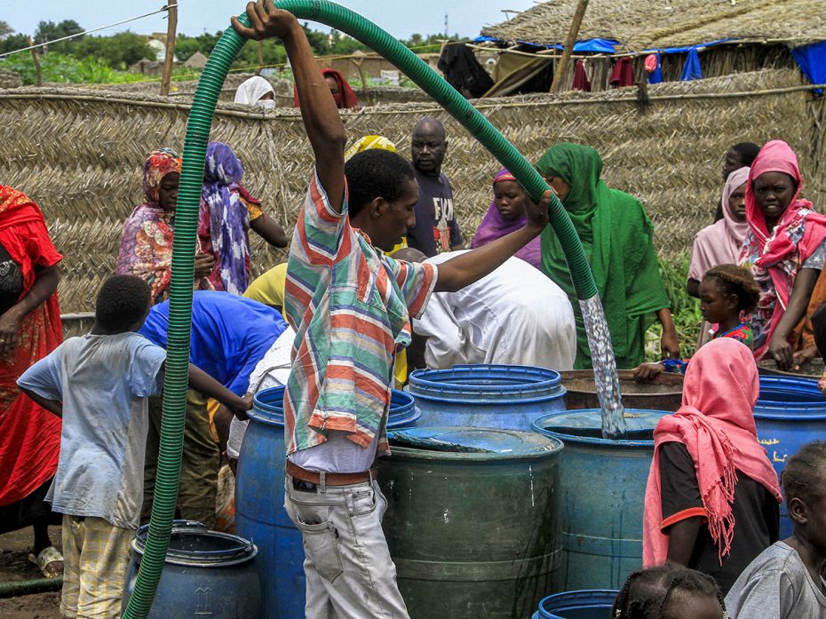 People collect clean water provided by a charity organisation to people in Gedaref in eastern Sudan,