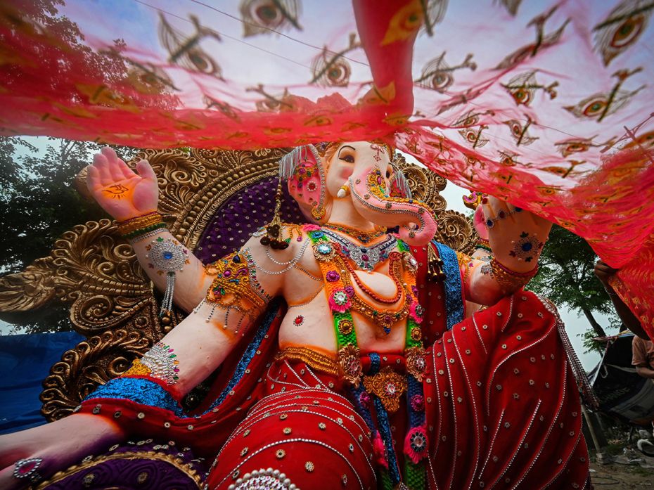 A bedecked Ganesha lounges regally on his throne at a pandal in Mayur Vihar, Delhi on the occasion o