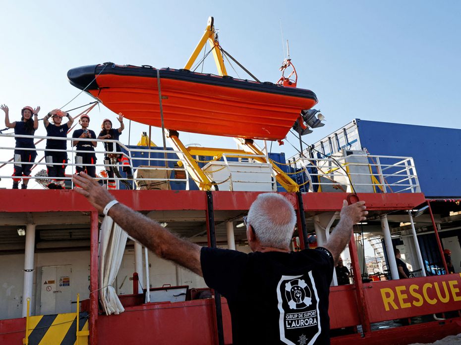 A volunteer from L'Aurora - Grup de Suport, a rescue ship support organisation, bids goodbye to the 