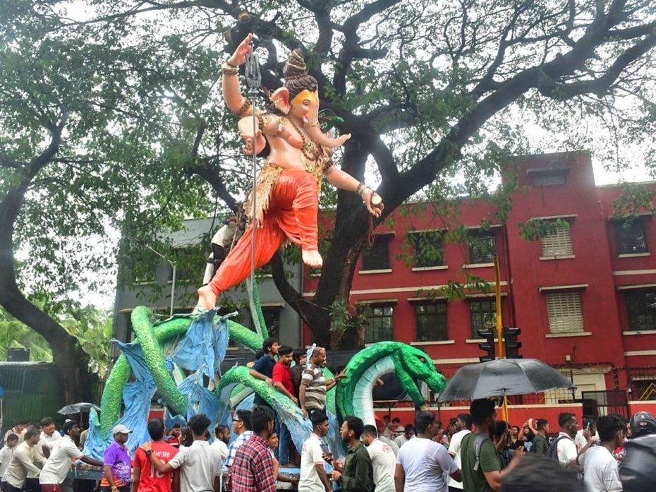 Devotees carry a leaping Ganesha to a pandal in Mumbai ahead of Ganesh Chaturthi Festival on August 