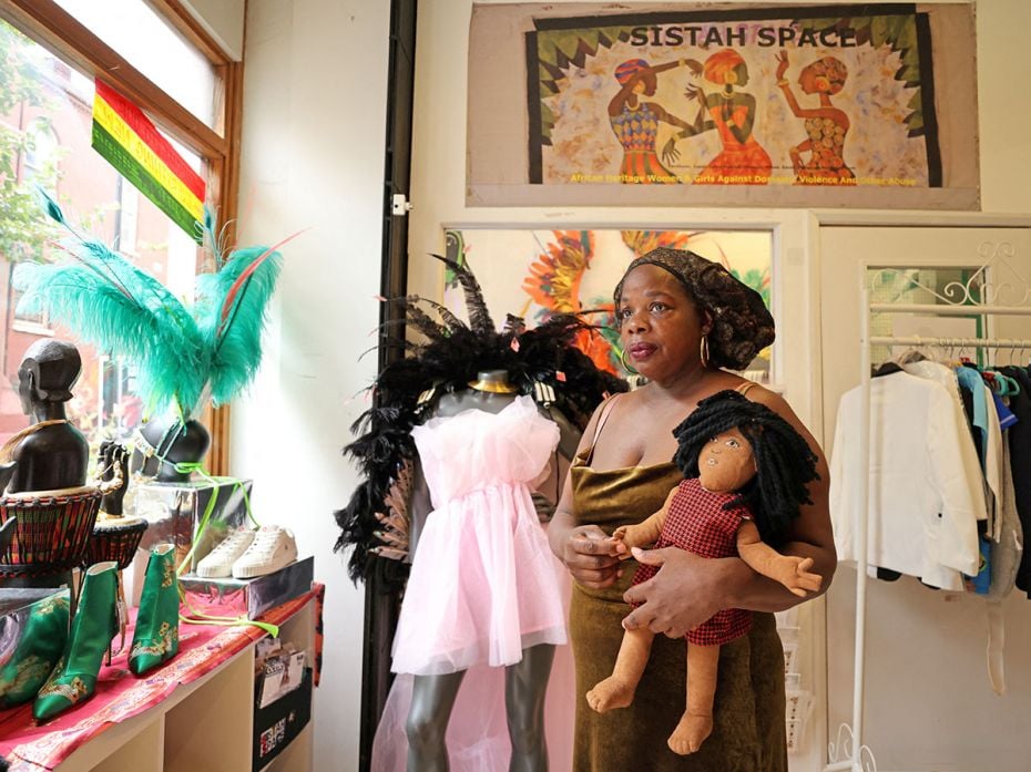 Ngozi Fulani, CEO and founder of Sistah Space, poses for a portrait holding a Survivor Doll at their